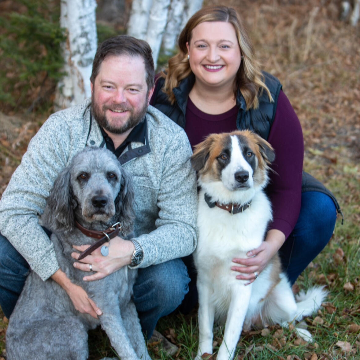 Hannah Schoneberger and her husband with their two dogs outdoors